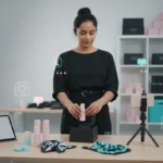 UK small business owner creating TikTok Shop content while packing orders in a bright studio setup.