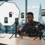 UK TikTok creator planning brand strategy in studio with smartphone, analytics and subtle TikTok UI elements.